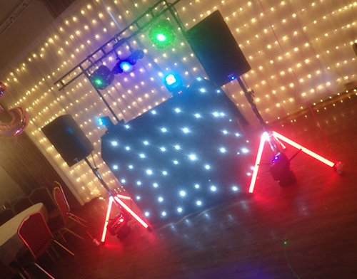 Beano Disco DJ set up with red white blue and green lighting