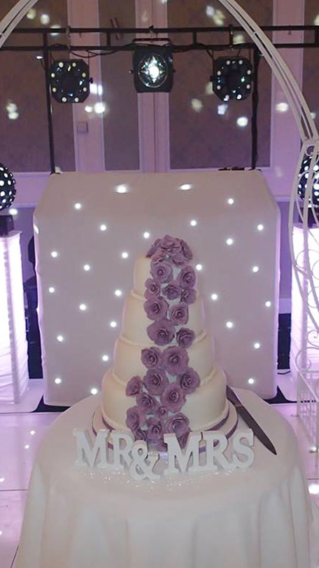 Wedding cake in front of Beano Disco set up